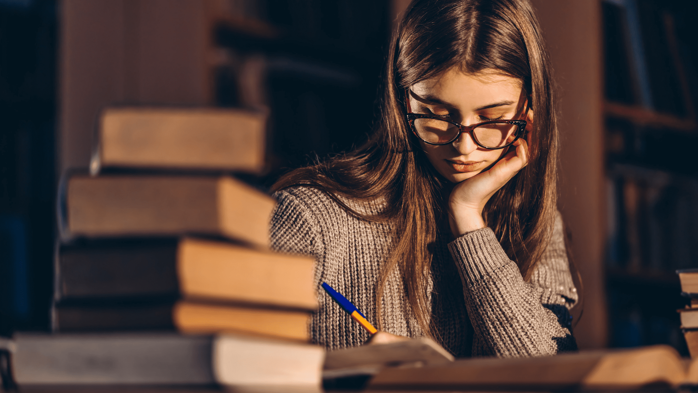 An MS1 student studying for the USMLE Step 1 in a library in front of several textbooks.