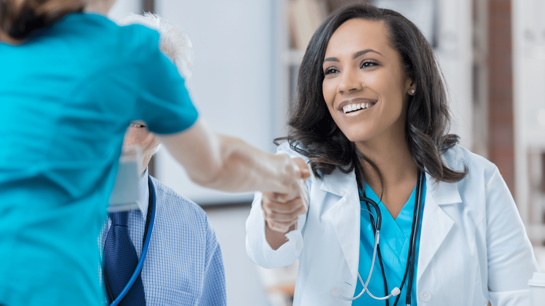 An attending shaking hands with a potential resident at a residency interview.