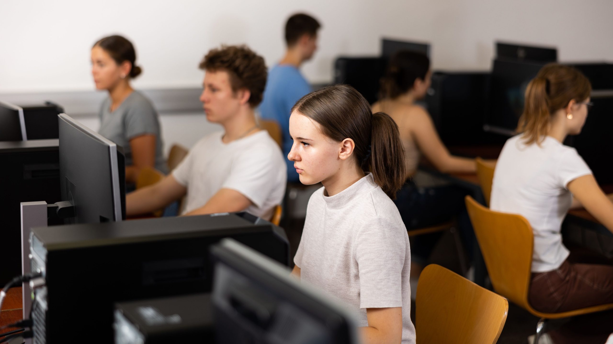 Medical DO students taking their COMLEX exam in a testing facility computer room.