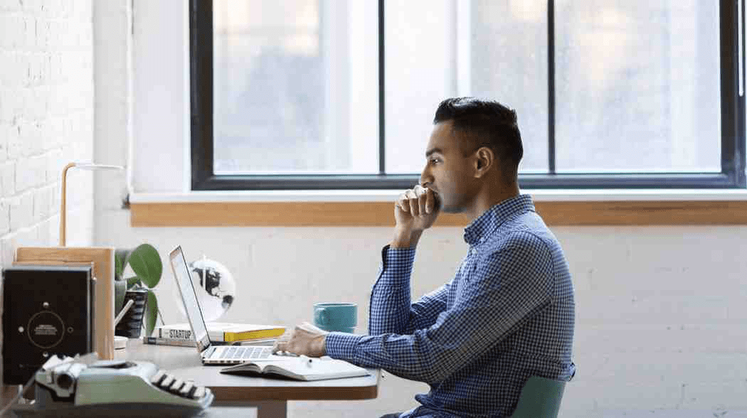 Student sitting at desk with laptop and studying for USMLE Step 3